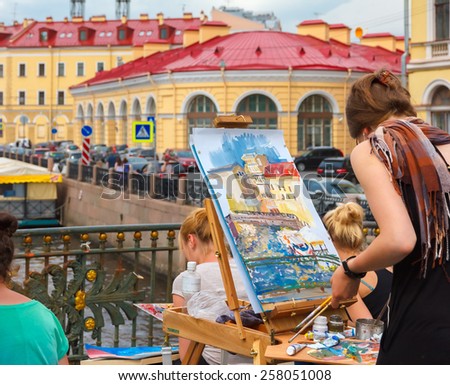 St. Petersburg, Russia - June 10, 2013: Young artists draw river landscape on the bridge over the Neva River.
