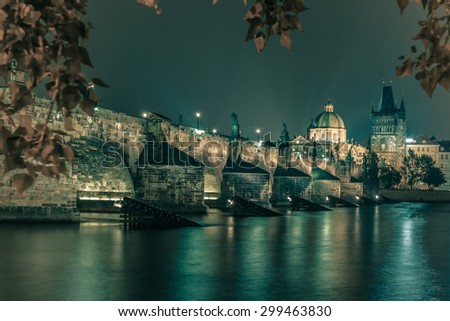 Charles Bridge and Old Town bridge tower at night in Prague, Czech Republic. Toning in cool tones