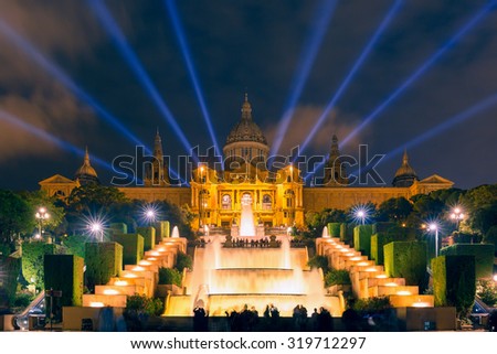Famous light show and magic fountains in front of the National Art Museum at Placa Espanya in Barcelona at night, Catalonia, Spain