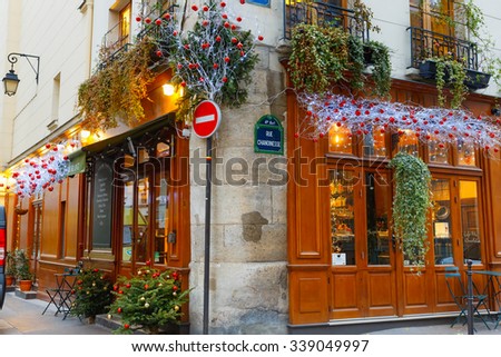 Paris, France - December 19, 2015: Typical Parisian cafes decorated for Christmas in the heart of Paris. Christmas is one of the main Catholic holidays, which is celebrated on a large scale throughout