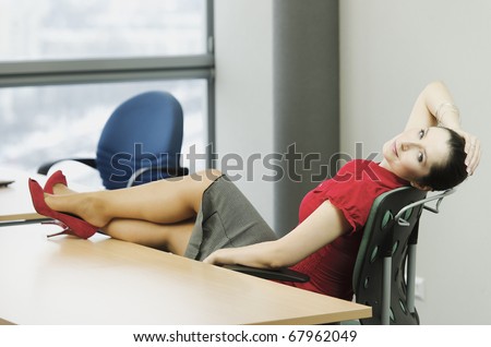 Woman in the office while resting with feet on the table