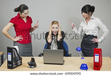 Two women in the office monitor your colleague at work