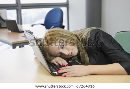 young blonde girl with red nails sleeping on the laptop keyboard