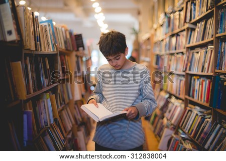 Young boy reading in a bookstore