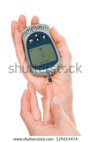 Diabetes patient measuring glucose level blood test using mini glucometer and small drop of blood from finger and test strips isolated on a white background Diabetes patient measuring glucose level blood test using mini glucometer and small drop of blood from finger and test strips isolated on a white background