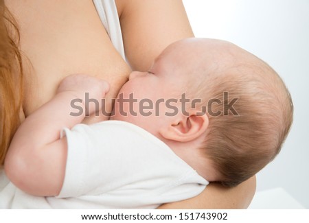 mother breast feeding child baby girl with milk