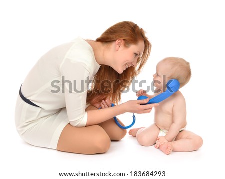 Young mother woman with daughter child baby kid girl playing calling by phone on a white background