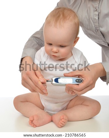 Mother measuring glucose level blood chemistry test from diabetes child baby using glucometer on a white background
