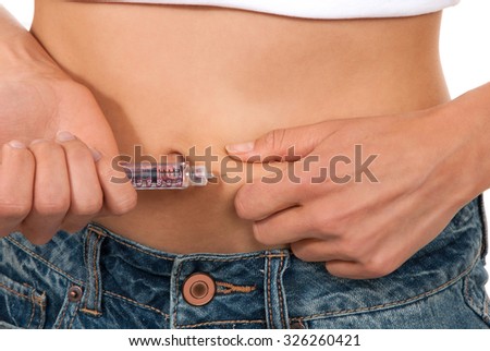 Diabetes patient insulin shot by syringe with dose of lantus subcutaneous abdomen vaccination isolated on a white background