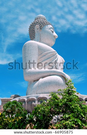 The Biggest  white holy Buddha in the world on Phuket Mountain Thailand surrounded by green tropical trees