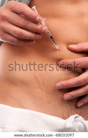 First type Diabetes patient giving himself abdomen insulin injection shot by single use syringe with dose of humalog isolated on a white background