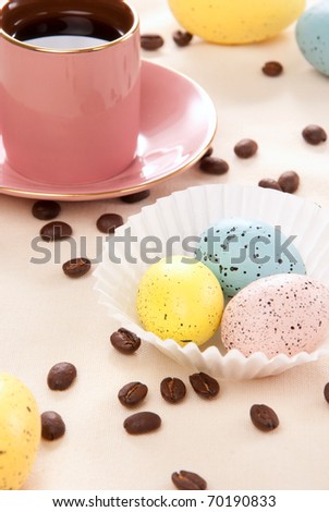 Easter eggs Sunday morning  pink, blue and yellow eggs, cup of espresso coffee and beans for happy Christian family on a pastel color background