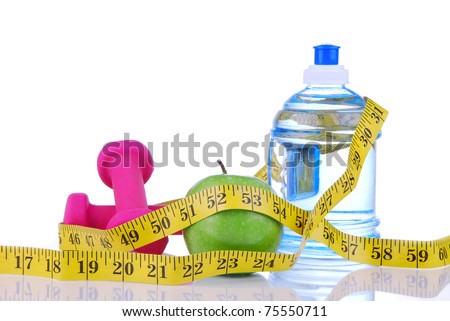 Diet diabetes weight loss concept with tape measure organic green apple, pink dumbbels and natural bottle of sparkling water on a white background. Focus on water