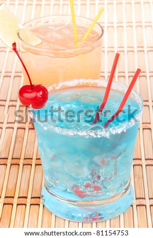 Blue margarita cocktail, Long island iced tea and tequila sunrise cocktails with alcohol, ice, maraschino cherry, straw