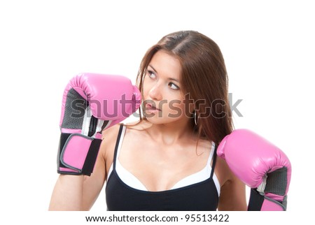 Pretty young boxing woman standing and defending by hands in pink and black box gloves isolated on a white background