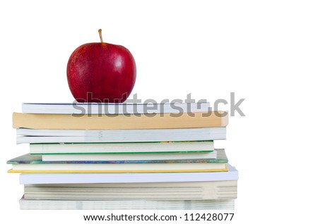 book stack with fresh red apple on top in white background
