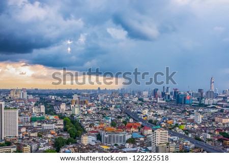 big city with rain cloud falling in background