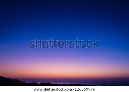 beautiful early morning dawn twilight with moon and star at the sea