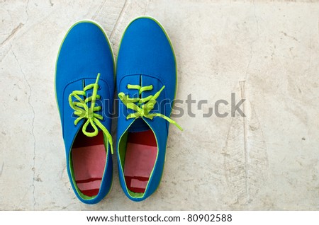 blue sneaker on cement floor