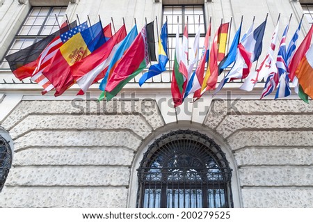 VIENNA, AUSTRIA - MAY 4: Flags on Hofburg palace on May 4, 2014 in Vienna. The Imperial Palace Hofburg is the most representative example of Vienna\'s characteristic variety of architecture styles.