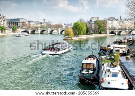 PARIS, FRANCE - MARCH 27: Ile de la Cite Island with the Pont Neuf bridge on March 27, 2014 in Paris. The Pont Neuf is the oldest standing bridge across the river Seine in Paris.