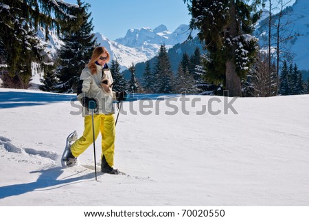 Woman snow-shoeing in the mountains