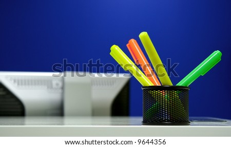 Soft-tip pens and display in office with blue wall