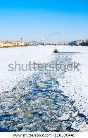 Ice-breaking tug opens the way across the frozen Neva river in a direction of the Palace Bridge. St.-Petersburg. Russia
