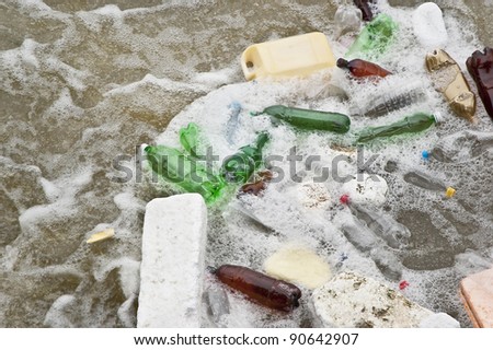 Plastic waste in a stream of dirty water