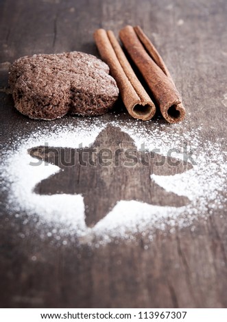 Christmas biscuits with icing sugar on wooden table