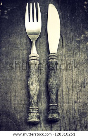 Fork and knife on old table Shallow depth of field. Black and white image.