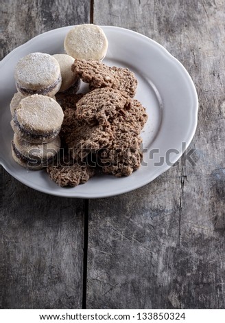 Cookies on plate on old wooden table
