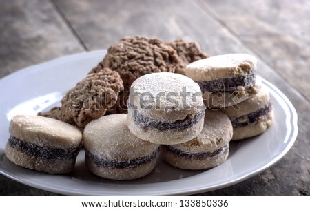 Cookies on plate on old wooden table,close up