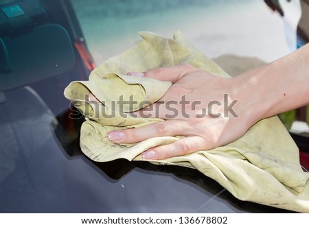 Female hand Washing the Windshield ,close up
