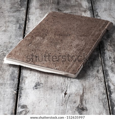 Old notebook on old wooden background