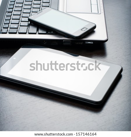 electronic devices on wooden table, close up