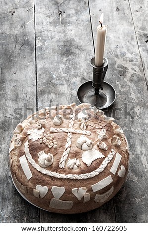 Festive bakery Holiday Bread and candle on wooden background