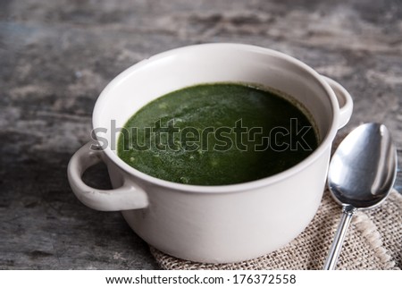 Closeup of broccoli cream soup on  table, natural light