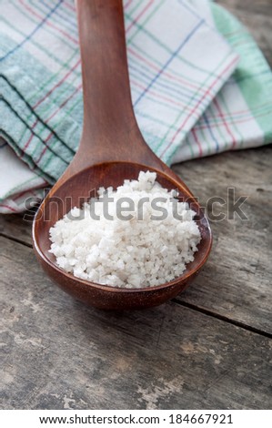 sea salt in a wooden spoon, close up photo