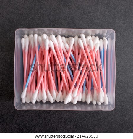 Box full of cotton swabs on table, from above