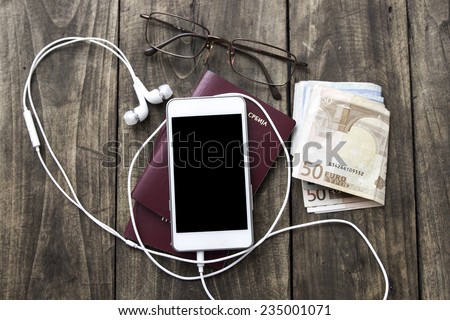 Preparation for travel, cell phone, money, passport  on wooden table