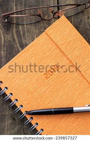 New beginning, new notebook and pen on rustic background