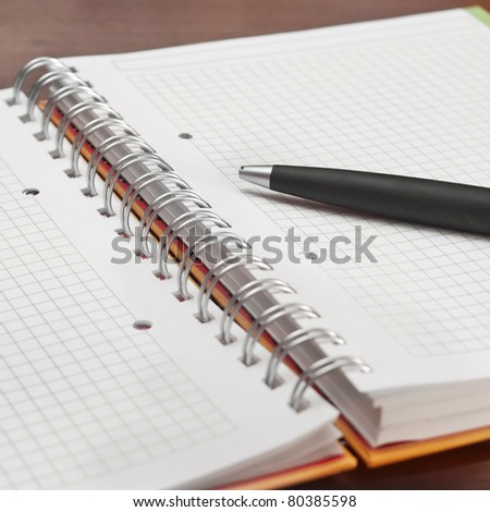 Black pencil on open white paper note book