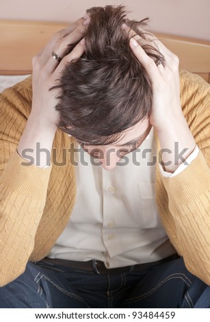 Woman having head ache holding head in hands