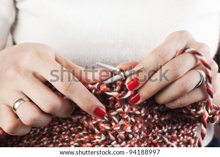 Hands of a young woman knitting