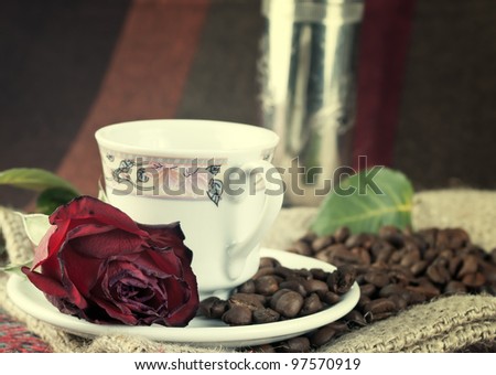 coffee grinder, coffee beans and roses on the table