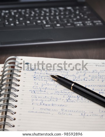 notebook,pen and netbook on desk