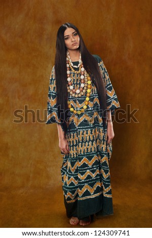 Woman in ethnic dress with long hair in the studio
