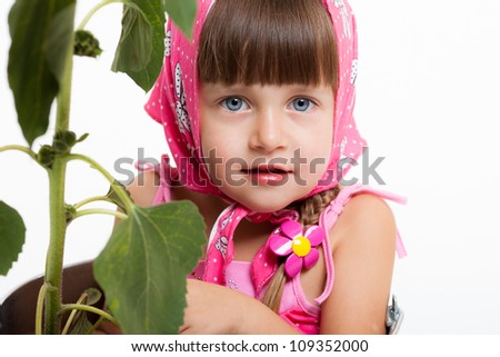a little girl in a bucket of sunflower