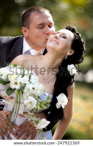 young and beautiful bride and groom in nature